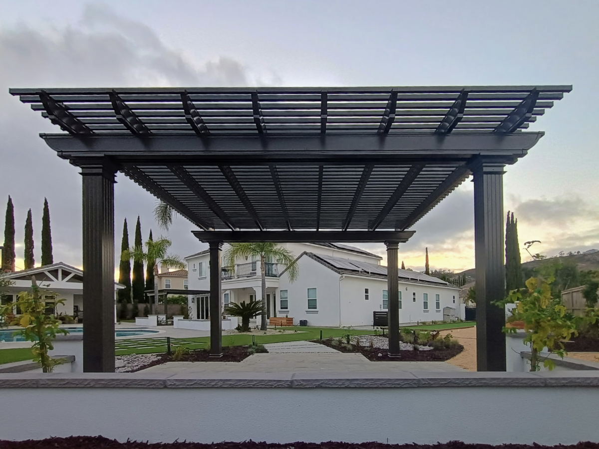 Side view of aluminum patio cover with integrated lighting and ceiling fan