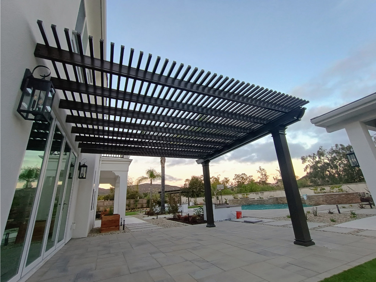 Solid-roof aluminum patio cover providing full shade over outdoor seating area