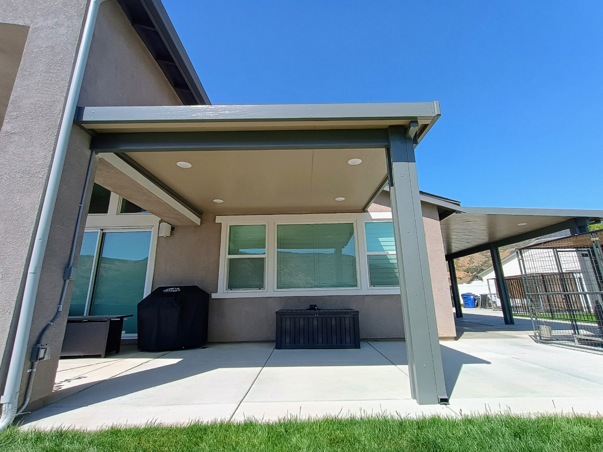 Wood-grain finish aluminum patio cover blending with home's exterior architecture