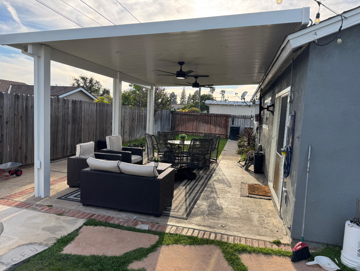 Large freestanding aluminum patio cover shading a backyard pool deck